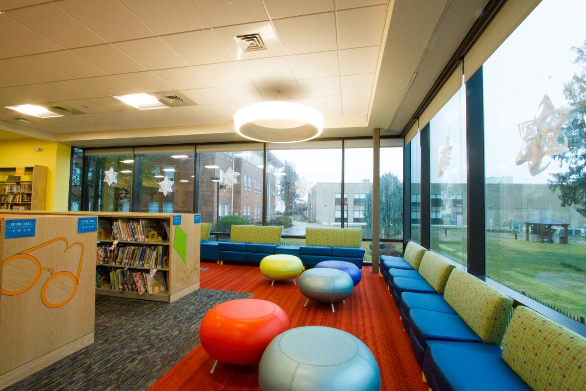 Variety of Funky Chairs and Seating Next to Exterior Windows and Childrens Books 2